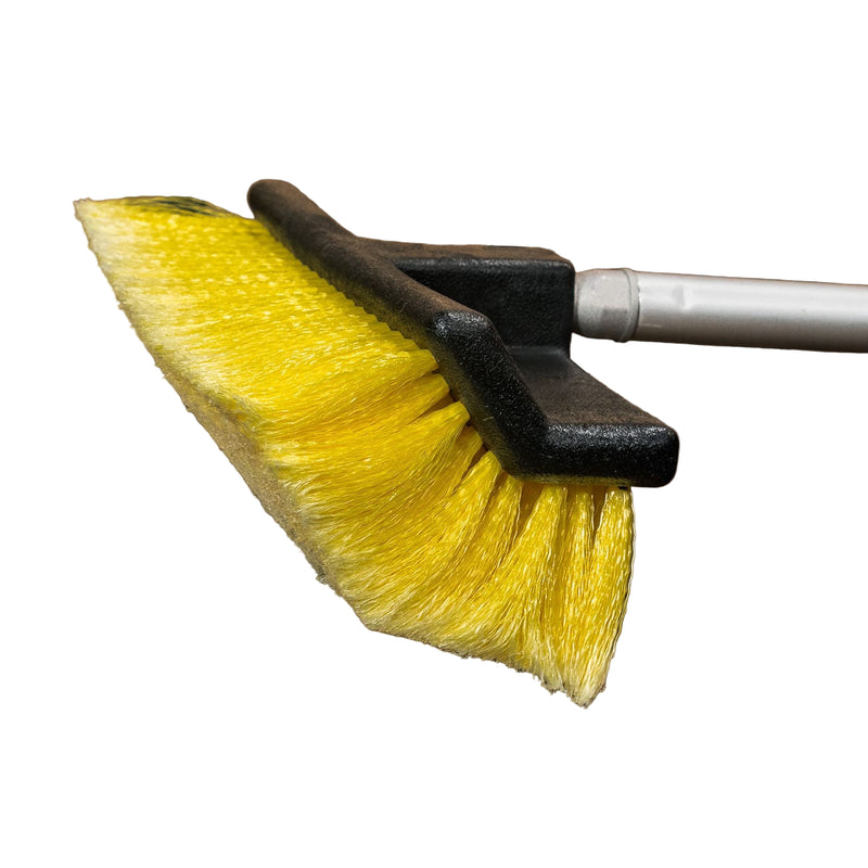 Yellow brush with black handle on a white background